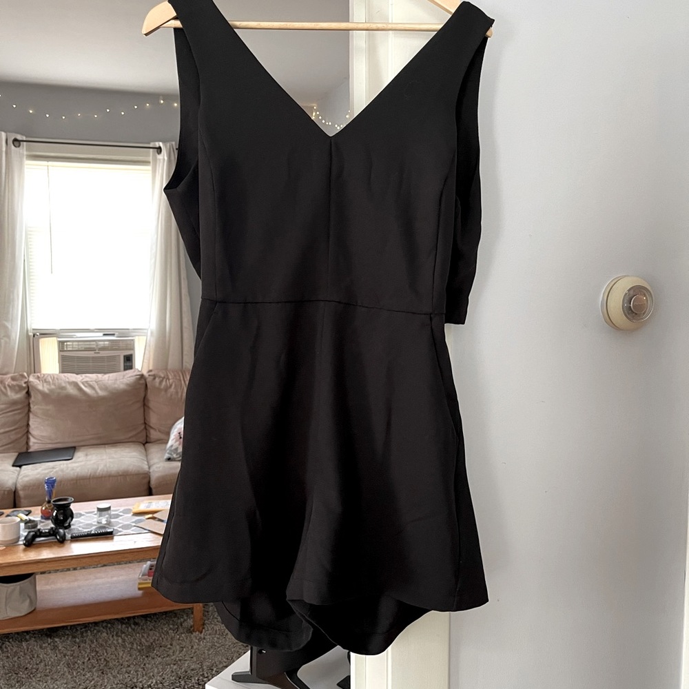 Short black romper with open back. Good condition.